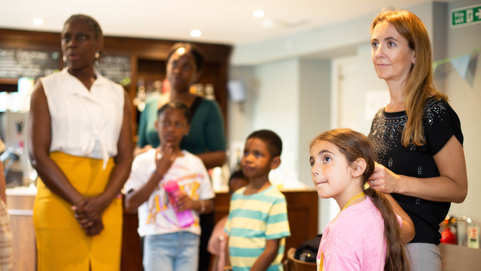 Two families arrive at the Charles Dickens Museum to a warm welcome. 